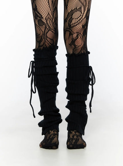 Ribbed Buttoned Leg Warmers CL523 Black front close-up both legs on model showing ruched ribbed texture and tie cord detail over floral fishnet tights