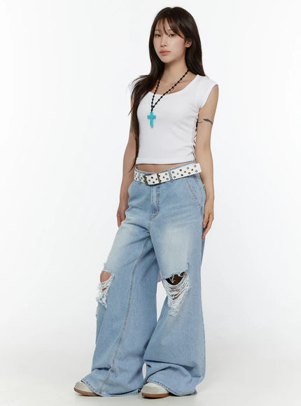 Ribbed Cap Sleeve Top CL508 White three-quarter front shot on model standing styled with cross necklace star belt and wide-leg jeans