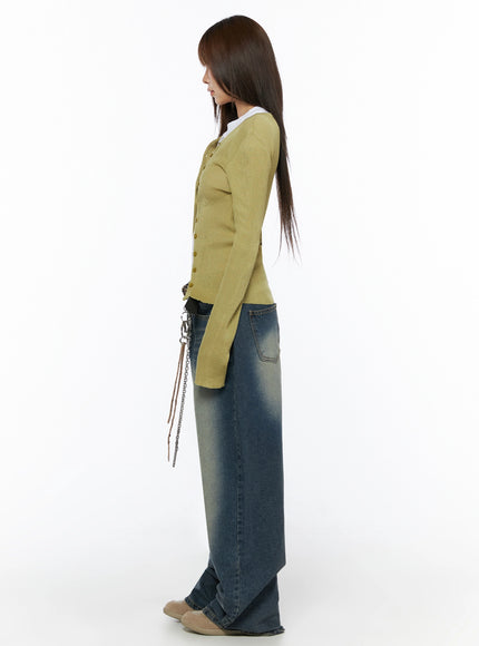 Ribbed Cardigan IL523 Dark green S/M full-body side shot on model standing profile, ribbed knit cardigan with button front, slim fit silhouette, layered over white tee