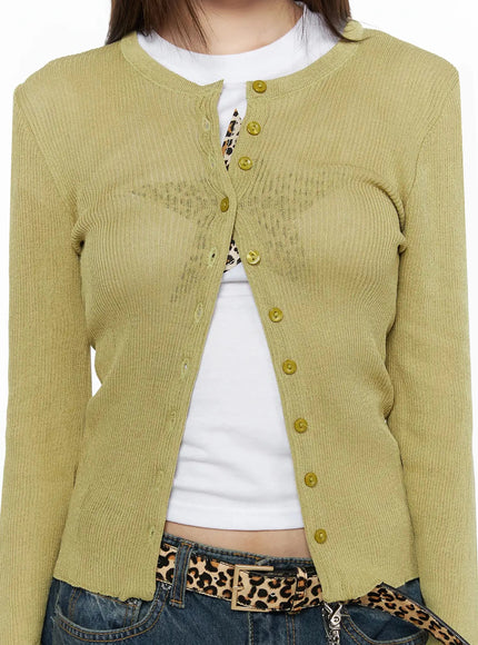 Ribbed Cardigan IL523 Dark green S/M close-up front detail shot on model, showing ribbed texture, gold buttons, frayed hem, layered over white tee with leopard belt