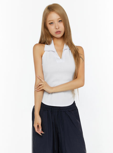 Ribbed Halter Neck Top IL524 White front shot on model with arms crossed at waist, showing fitted ribbed halter silhouette and open collar neckline