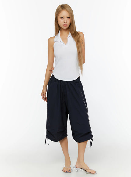 Ribbed Halter Neck Top IL524 White full-length front shot on model standing straight, paired with navy wide-leg cropped pants with white piping
