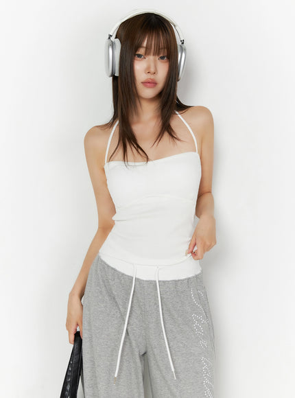LEWKIN Ribbed Halter Sleeveless Top IL515 White front view on model wearing headphones styled with gray wide-leg sweatpants