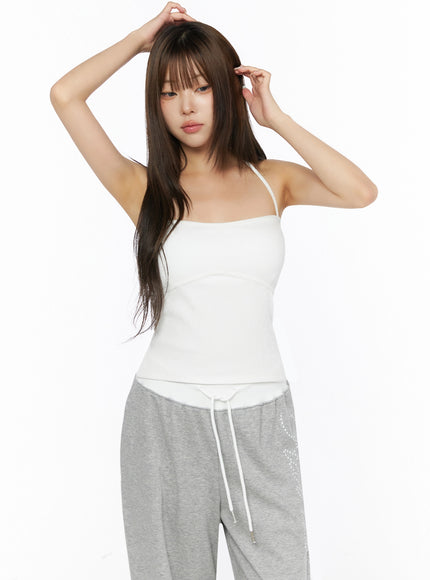 Ribbed Halter Sleeveless Top IL515 White front shot on model arms raised behind head revealing halter strap and corset-style bust seam detail