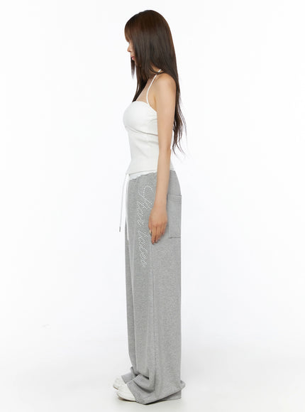 Ribbed Halter Sleeveless Top IL515 White side shot on model showing profile silhouette halter strap and rhinestone graphic sweatpants length
