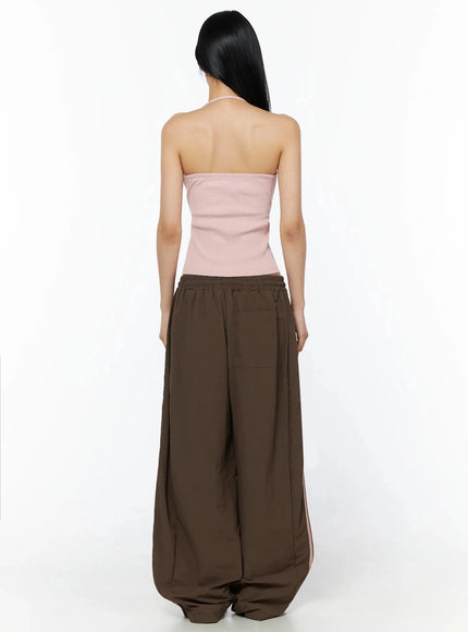 Ribbed Halter Top IL509 Pink back view model showing open back halter tie neck ribbed top with exposed spine and wide-leg brown pants