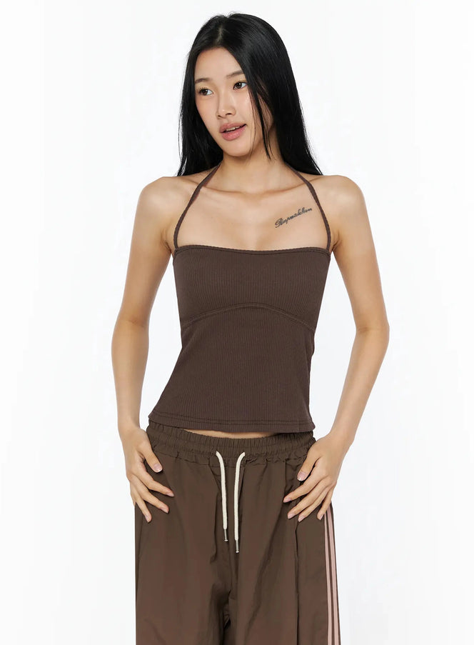 Ribbed Halter Top IL509 Brown front view model wearing halter neck ribbed crop top with curved seam detail paired with brown track pants