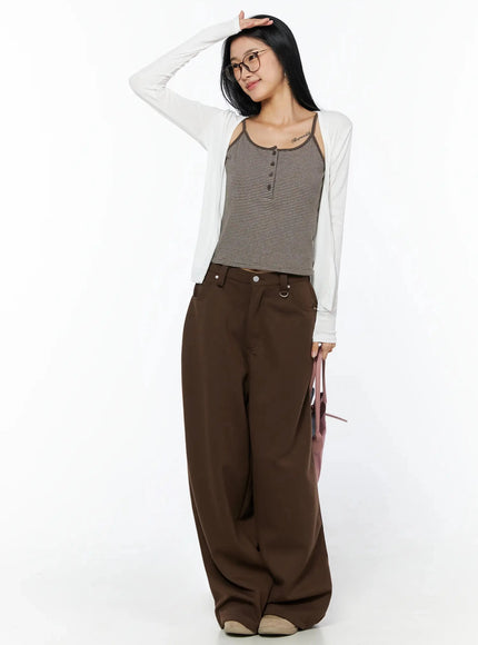 Ribbed Open Knit Cardigan IL509 White three-quarter front shot on model with hand raised to forehead, holding pink tote bag, styled with striped cami and brown wide-leg pants