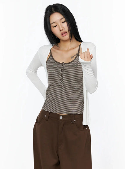 Ribbed Open Knit Cardigan IL509 White cropped front shot on model looking down, open cardigan over striped henley cami, sheer lightweight knit fabric detail visible