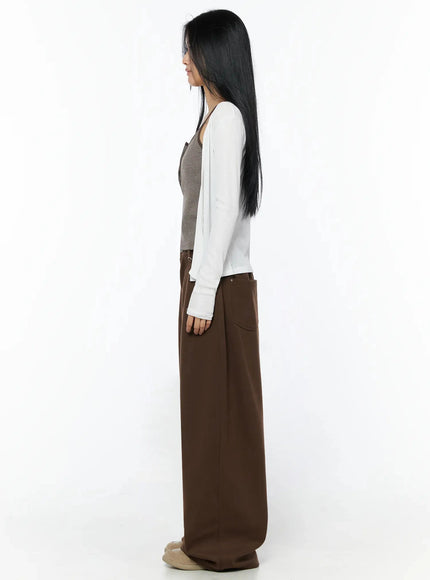 Ribbed Open Knit Cardigan IL509 White full-body side shot on model standing sideways, showing silhouette, sleeve length, and cropped hem over brown wide-leg pants