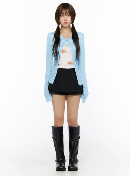 Ribbed Round Neck Cardigan IL515 Light blue full-body front model shot standing straight, styled with goldfish graphic tank, black mini skirt, and knee-high boots