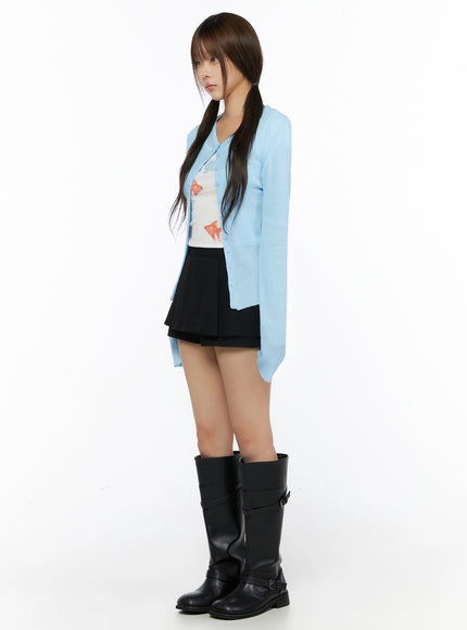 Ribbed Round Neck Cardigan IL515 Light blue side profile full-body model shot showing silhouette, ribbed knit cardigan with flared cuffs and asymmetric hem
