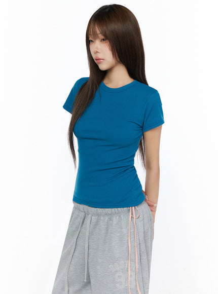 Ribbed Short Sleeve Tee IL515 Teal side shot model wearing fitted ribbed short sleeve crop tee with visible rib texture styled with gray wide-leg pants