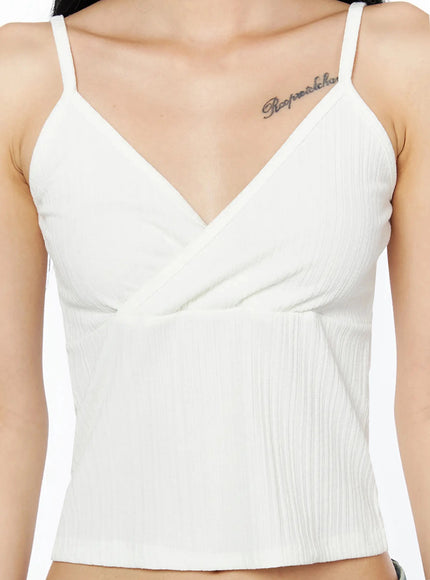 Ribbed Sleeveless Top IL509 White close-up front detail shot, V-neck wrap crossover bust with ribbed texture and thin spaghetti straps visible on model