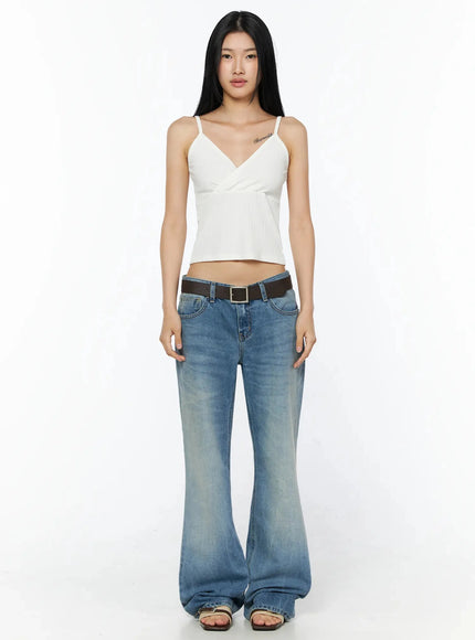 Ribbed Sleeveless Top IL509 White front full-body shot, model standing straight arms down, spaghetti-strap ribbed wrap crop top with flared low-rise jeans and sandals