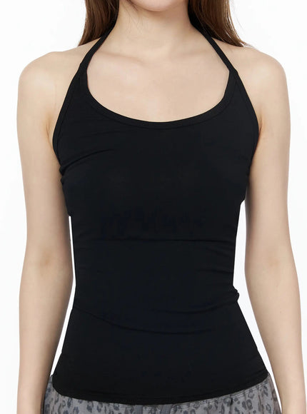Ribbed Slim Fit Halter Top IU525 Black close-up front shot on model showing scoop neckline halter strap construction and form-fitting ribbed texture