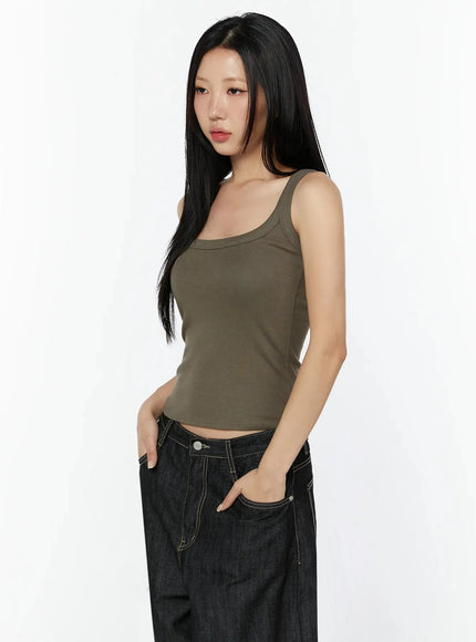 Ribbed Slim Tank Top IL516 Dark brown side model shot with hand in pocket showing slim cropped length square neckline and strap detail with black denim