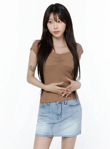 Ribbed Square Neck Knit Top IL502 Brown front shot on model with hands clasped at waist styled with denim mini skirt ribbed texture visible