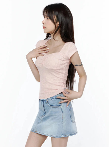 Ribbed Square Neck Knit Top IL502 Pink side shot on model hand on chest and hip showing body-hugging ribbed silhouette with denim mini skirt
