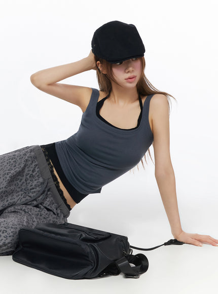 Ribbed Square Neck Padded Tank Top IU525 Dark gray seated editorial shot on model with black baker boy cap, ribbed tank, leopard pants and black leather bag