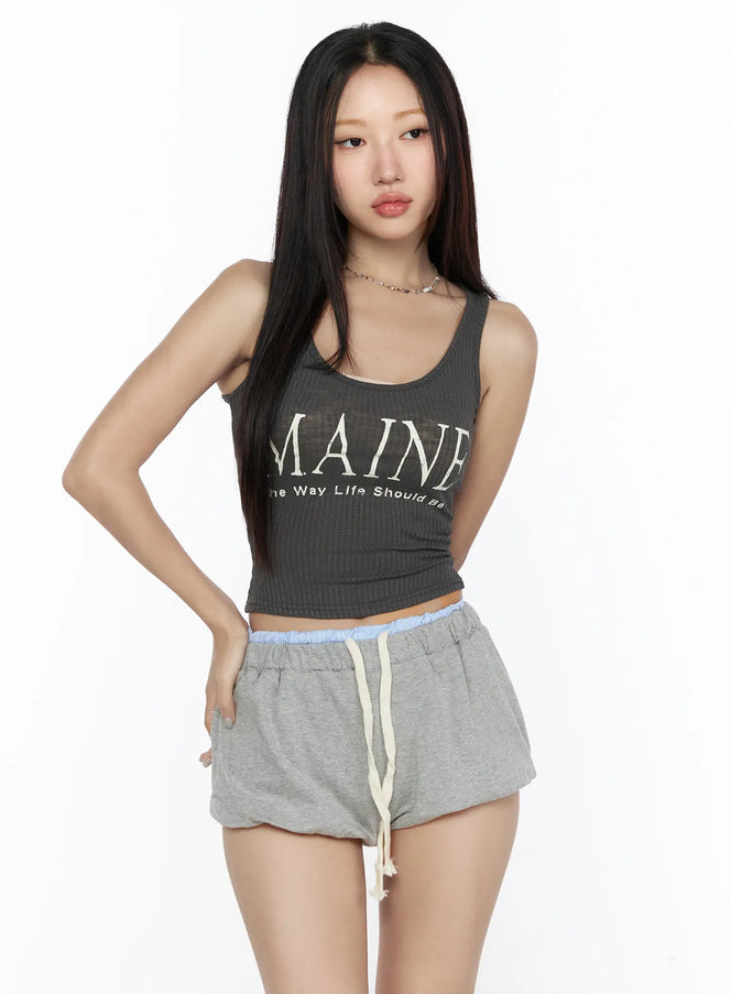 Ribbed Tank Top CL527 charcoal gray front view on model, cropped ribbed tank with MAINE letter graphic, scoop neck, styled with gray mini shorts and chain necklace