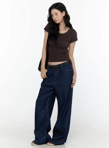 Ribbed U-Neck Tee CL520 Dark brown full-body side-angle model shot slim ribbed knit crop tee with cap sleeves paired with wide-leg blue denim and white sandals