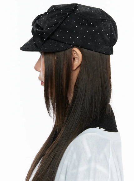 Ribbon Cubic Hat CL517 Black pure side profile close-up on model, rhinestone-studded satin newsboy cap showing brim silhouette and bow placement