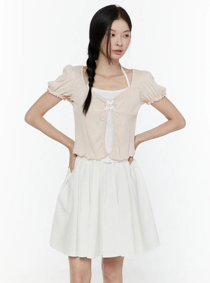 Ribbon Detail Puff Short Sleeve and Halter Set IL506 Light pink front view on model hands on hips open-front cardigan showing double bow detail puff sleeves and ruffled cuffs