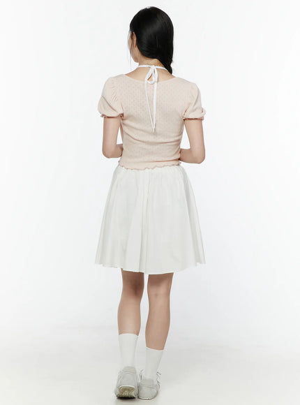 Ribbon Detail Puff Short Sleeve and Halter Set IL506 Light pink back view on model revealing halter strap tie at nape pointelle knit fabric puff sleeves and scalloped hem over white skirt