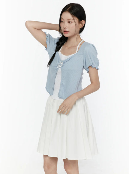 Ribbon Detail Puff Short Sleeve and Halter Set IL506 blue three-quarter view on model with hand raised showing puff sleeve ruffled cuff double satin bow closure over white halter and skirt