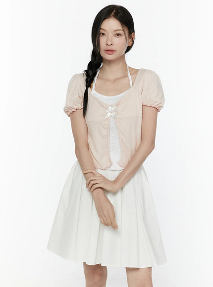 Ribbon Detail Puff Short Sleeve and Halter Set IL506 Light pink front view on model with braided hair arms relaxed open-front showing satin bow detail over white halter and flared white skirt