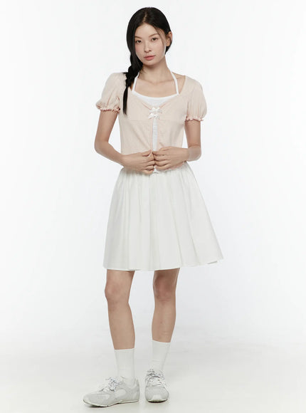 Ribbon Detail Puff Short Sleeve and Halter Set IL506 Light pink front view on model standing upright hands clasped at waist styled with white mini skirt white socks and sneakers