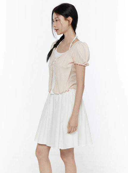Ribbon Detail Puff Short Sleeve and Halter Set IL506 Light pink side view on model with braided hair hands at sides showing puff sleeve silhouette and scalloped hem over white skirt