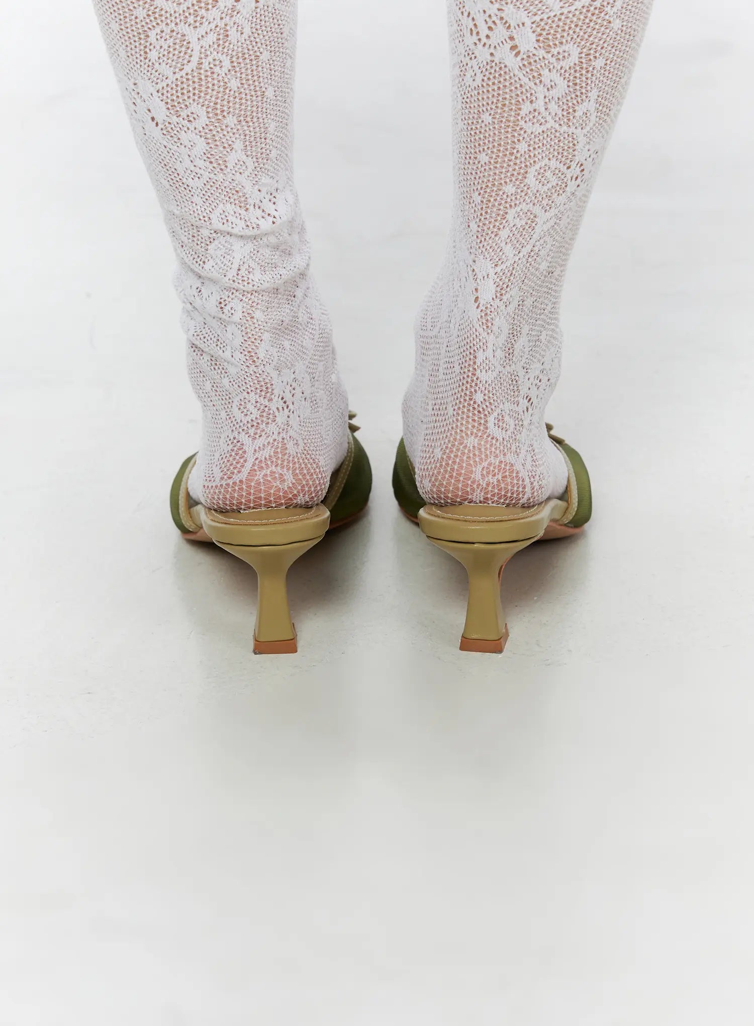 Ribbon Detail Sandal Heels CU524 Green back close-up on model showing sculptured kitten heel shape and open back mule silhouette with lace socks