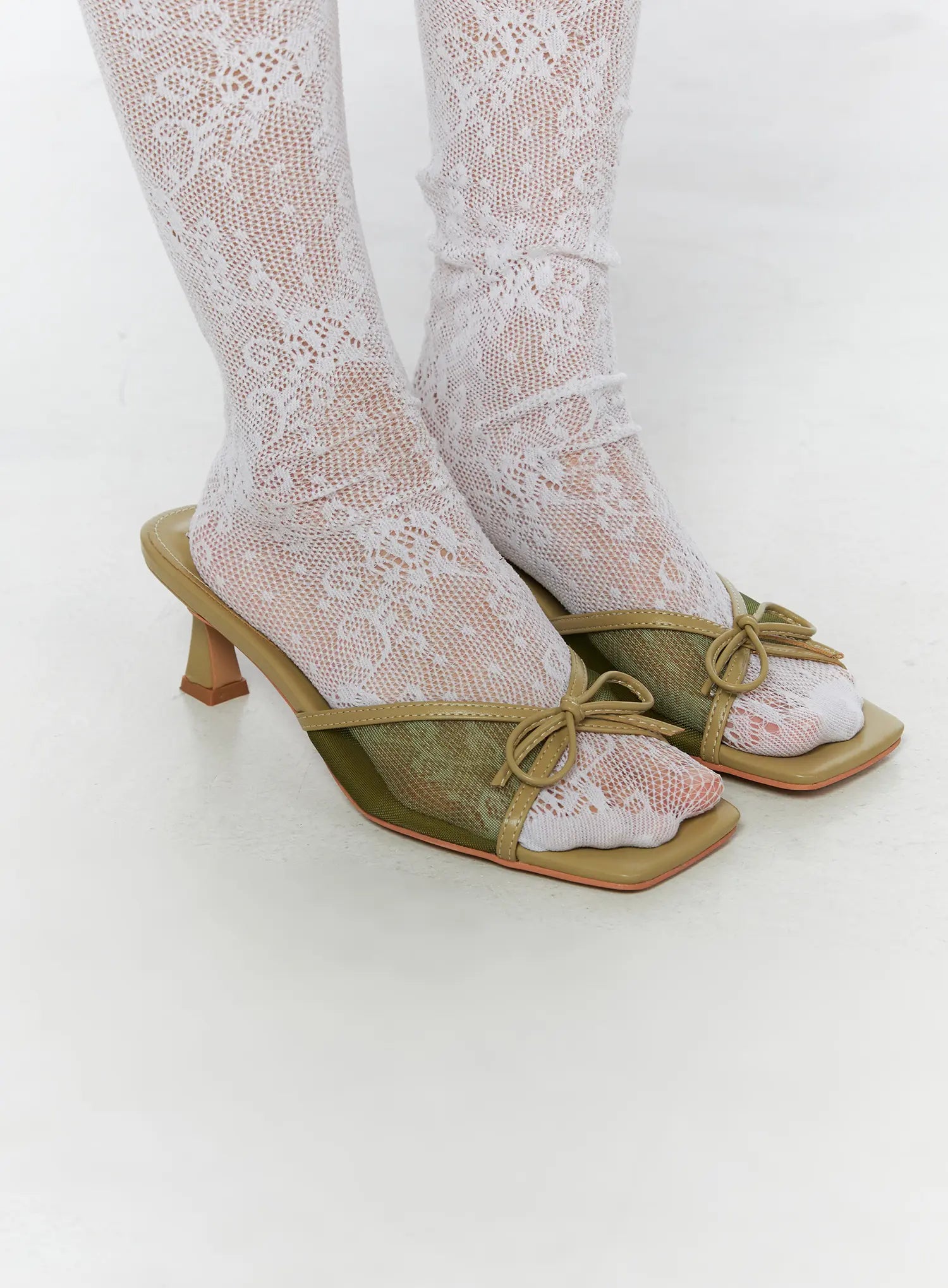 Ribbon Detail Sandal Heels CU524 Green three-quarter front close-up on model showing mesh vamp bow tie detail and kitten heel with lace socks
