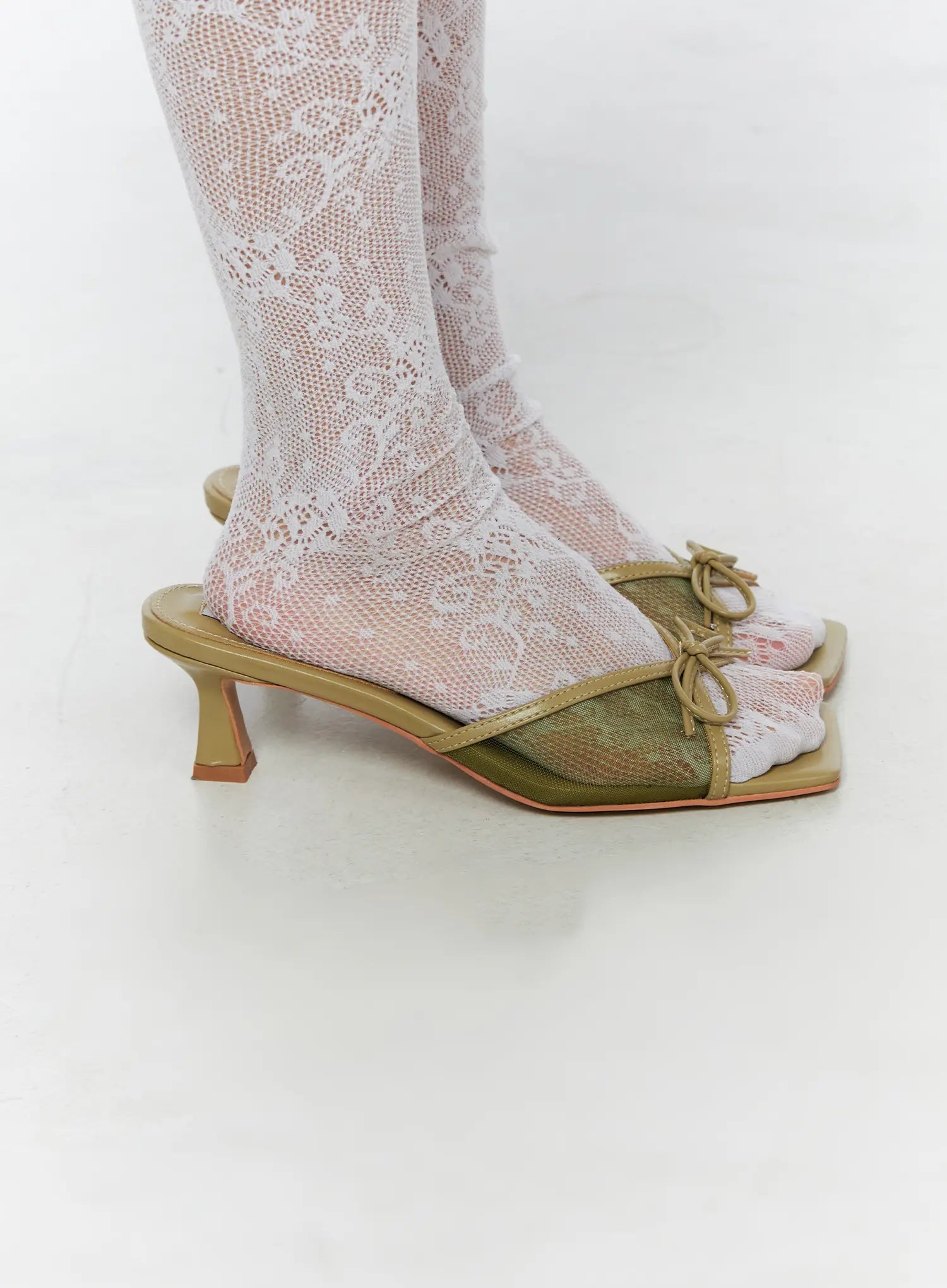 Ribbon Detail Sandal Heels CU524 Green side close-up on model highlighting single shoe profile with sculptured kitten heel mesh upper and bow