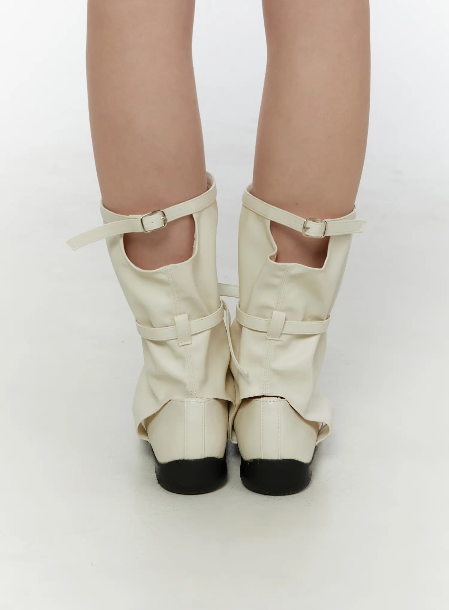 Ribbon Flat Ankle Boots CL507 Light beige back view on model standing straight showing rear gaiter panel dual buckle straps and open heel cutout
