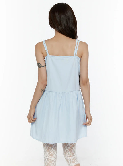 Ribbon Mini Dress CL508 Light blue back shot on model showing double spaghetti straps, straight back neckline and tiered gathered skirt hem with lace tights