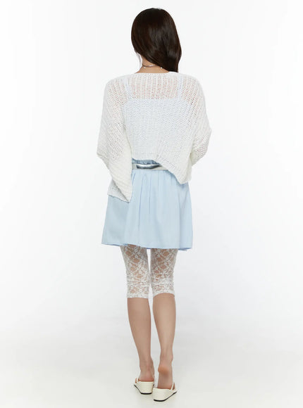 Ribbon Mini Dress CL508 Light blue back shot on model styled with white open-knit cardigan and silver belt, showing flowy tiered skirt and lace capri leggings