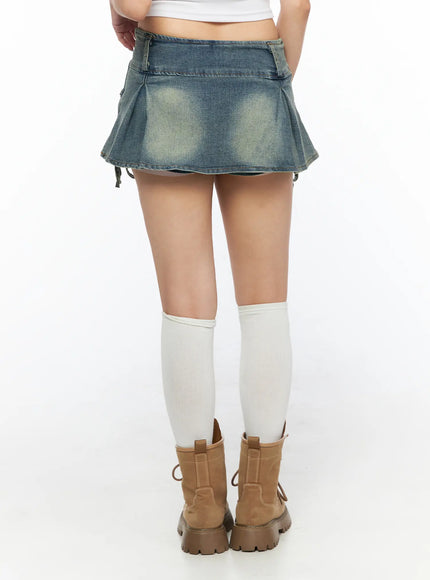Ribbon Pleated Denim Mini Skirt CL514 Blue back shot on model showing pleated hem vintage wash fading and side ribbon ties styled with white knee socks and tan boots