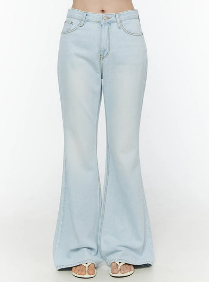 LEWKIN Ripley Light Washed Flared Jeans IL506 Light blue Size S front close-up on model showing waistband button fly front pockets and flared denim leg with white sandals