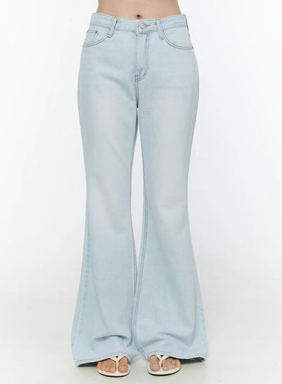LEWKIN Ripley Light Washed Flared Jeans IL506 Light blue Size S front close-up on model showing waistband button fly front pockets and flared denim leg with white sandals