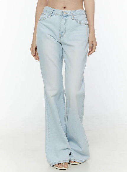 Ripley Light Washed Flared Jeans IL506 Light blue front waist-down shot on model showing low-rise waistband button closure front pockets and flared leg with white sandals