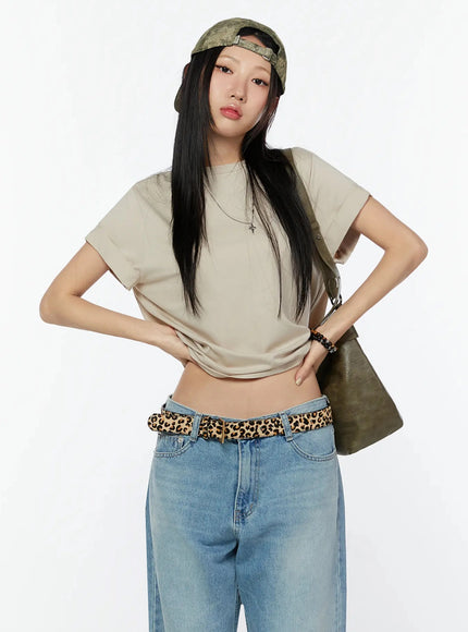 LEWKIN Rolled Cuff Loose Tee IU524 Beige front shot on model wearing cap, leopard belt, wide-leg jeans, cross necklace, hands on hips