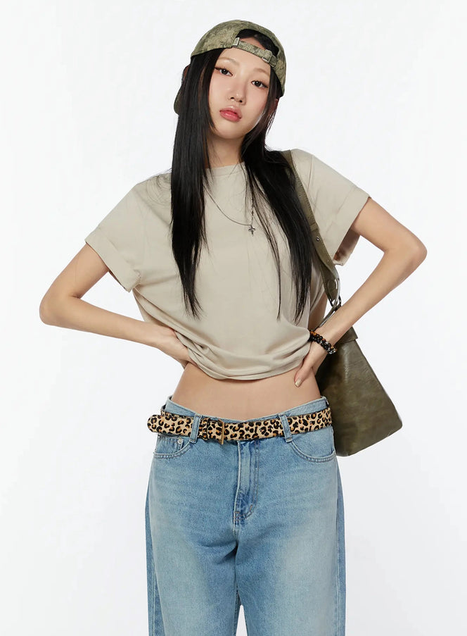 LEWKIN Rolled Cuff Loose Tee IU524 Beige front shot on model wearing cap, leopard belt, wide-leg jeans, cross necklace, hands on hips