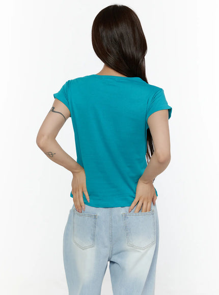 Rolled-Up Graphic Slim Fit Tee CL507 Blue back shot on model showing plain teal back panel rolled cap sleeves and slim fit silhouette paired with light wash jeans