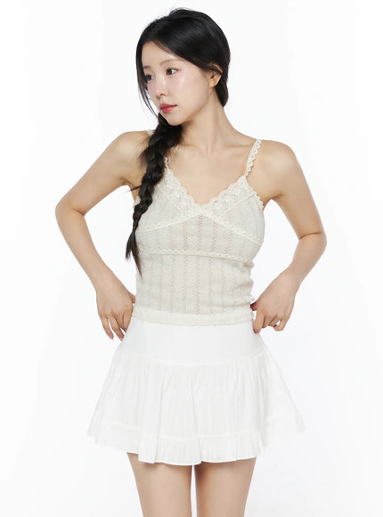 Romantic Lace Cami Top IU525 Light beige front model close-up shot showing floral lace V-neckline trim, crossover bust seam, and vertical pointelle knit texture