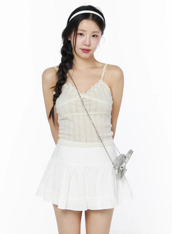 LEWKIN Romantic Lace Cami Top IU525 Light beige S/M front model shot with braided hair, lace V-neck trim, pointelle knit, styled with white mini skirt and silver bag