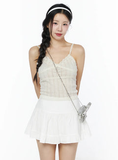 LEWKIN Romantic Lace Cami Top IU525 Light beige S/M front model shot with braided hair, lace V-neck trim, pointelle knit, styled with white mini skirt and silver bag