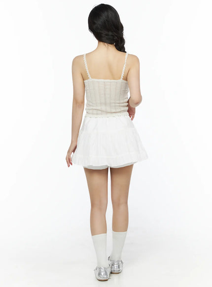Romantic Lace Cami Top IU525 Light beige back model shot showing lace-trimmed spaghetti straps, open back, vertical pointelle knit, white socks and silver sandals
